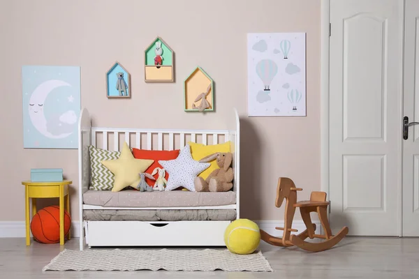 Cozy room with stylish furniture and toys for baby. Interior design