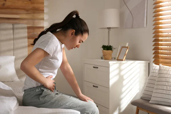 家のベッドで胃の痛みに苦しんでいる若い女性 テキストのためのスペース 食中毒 — ストック写真