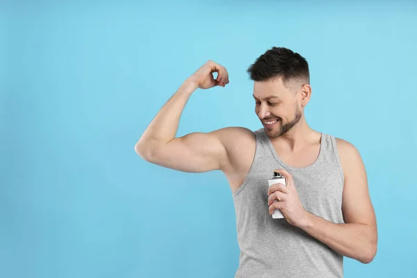 Handsome Man Applying Deodorant Turquoise Background Space Text — Stock Photo, Image
