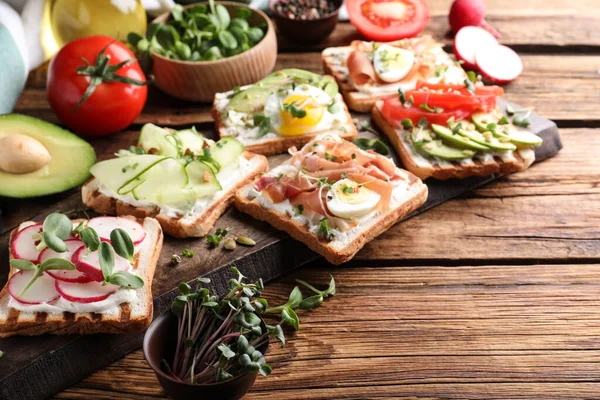 Different Delicious Sandwiches Microgreens Wooden Table — Stock Photo, Image