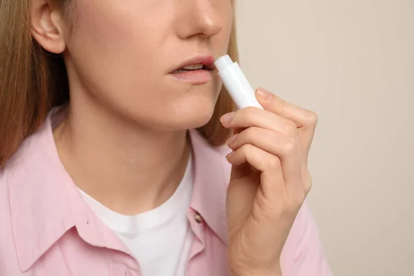 Woman Herpes Applying Lip Balm Beige Background Closeup — Stock Photo, Image