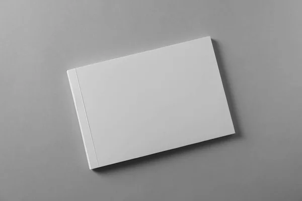 Brochure with blank cover on light grey background, top view