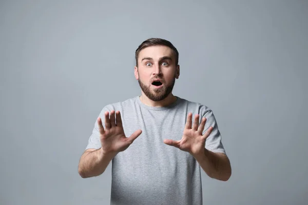 Young Man Feeling Fear Grey Background — Stock Photo, Image