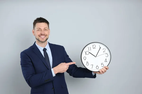 Homem Negócios Feliz Segurando Relógio Fundo Cinza Gestão Tempo — Fotografia de Stock