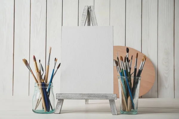 Easel Blank Canvas Brushes White Wooden Table — Stock Photo, Image