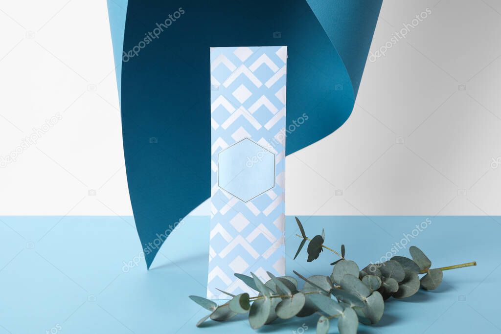 Scented sachet and eucalyptus branches on color background