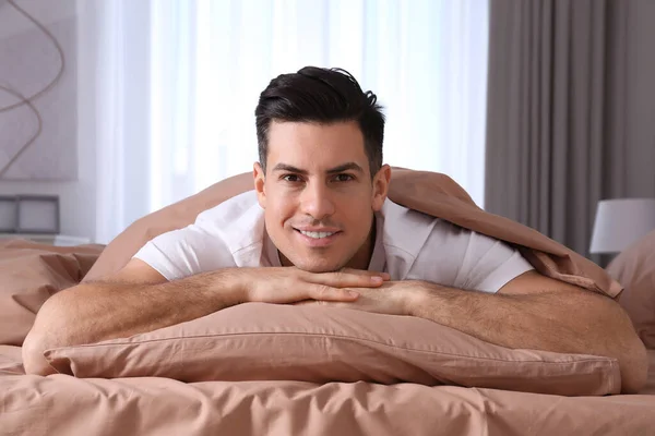 Man Lying Comfortable Bed Beige Linens — Stock Photo, Image