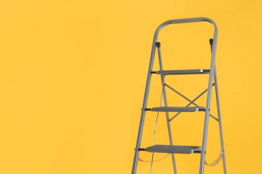Sarı arka planda modern metal merdiven. Metin için boşluk