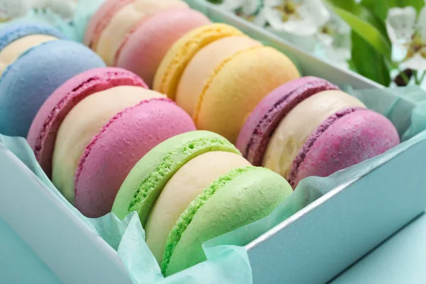 Muchos Deliciosos Macarons Coloridos Caja Sobre Fondo Azul Claro Primer —  Fotos de Stock