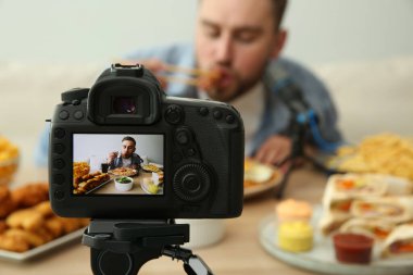 Gıda blogcusu yemek programının arka planda ışığa karşı, kamera ekranına odaklan. Mukbang vlog