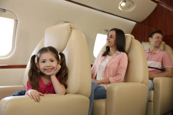 Happy family together in airplane during flight