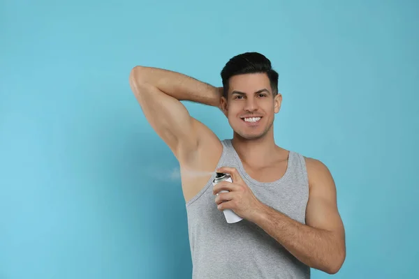 Handsome Man Applying Deodorant Armpit Turquoise Background Space Text — Stock Photo, Image