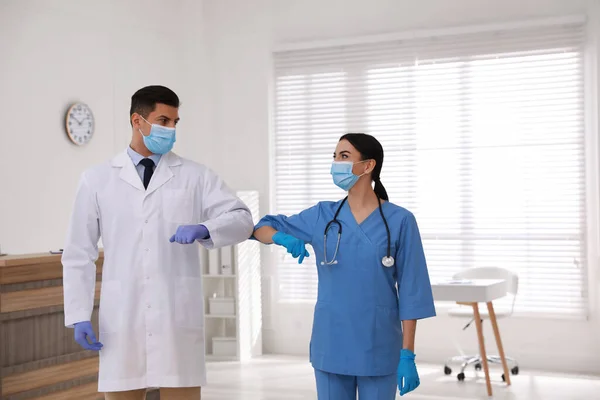 마스크를 의사들은 진료소에서 팔꿈치를 흔들면서 인사를 — 스톡 사진