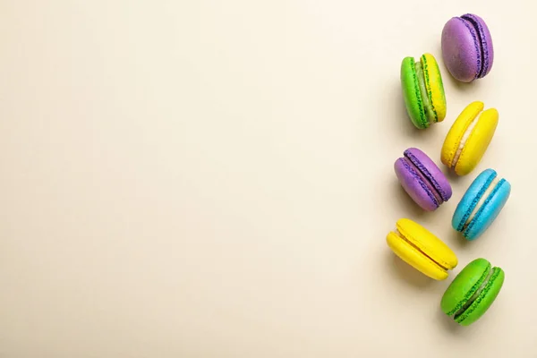 Deliciosos Macarons Coloridos Fundo Bege Flat Lay Espaço Para Texto — Fotografia de Stock