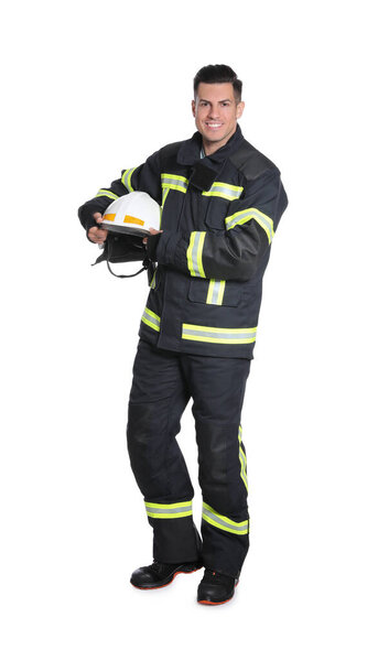 Full length portrait of firefighter in uniform with helmet on white background