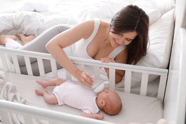 Happy Young Mother Feeding Her Newborn Baby Bottle Bedroom Home — Stock Photo, Image