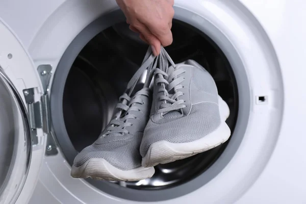 Woman Putting Pair Sport Shoes Washing Machine Closeup — Stock Photo, Image