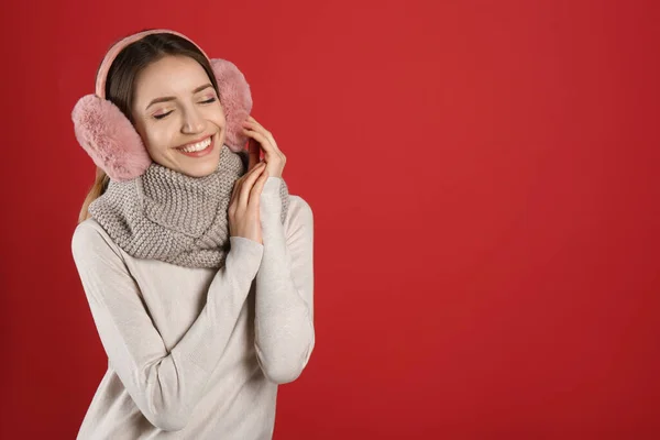 Mujer Feliz Con Orejeras Calientes Sobre Fondo Rojo Espacio Para —  Fotos de Stock