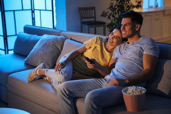 Happy Mixed Race Couple Relax On Couch In Living Room Watch Movie