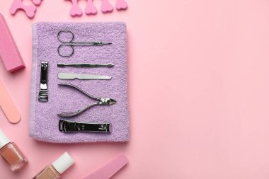 Pembe arka planda manikür aletleri ve aksesuarlar var. Metin için boşluk