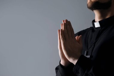 Gri arka planda dua eden rahip, yakın plan. Metin için boşluk