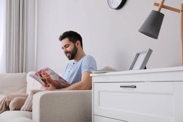 Jongeman Die Thuis Sporttijdschriften Leest Bank — Stockfoto