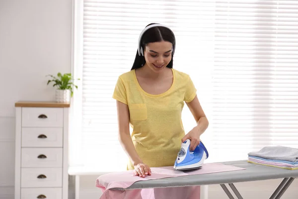 Young Woman Listening Music While Ironing Clothes Home — Stock Photo, Image