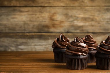 Tahta masada kremalı lezzetli çikolatalı kekler. Metin için boşluk