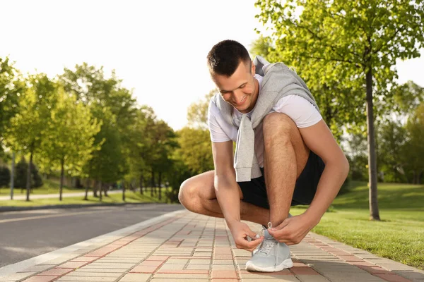 Young Man Tying Laces Sneakers Outdoors Morning Fitness — Stock Photo, Image