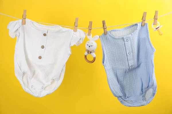 Baby Clothes Accessories Hanging Washing Line Yellow Background — Stock Photo, Image