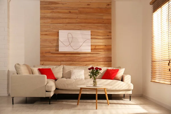 Modern comfortable sofa near wall in room. Interior design