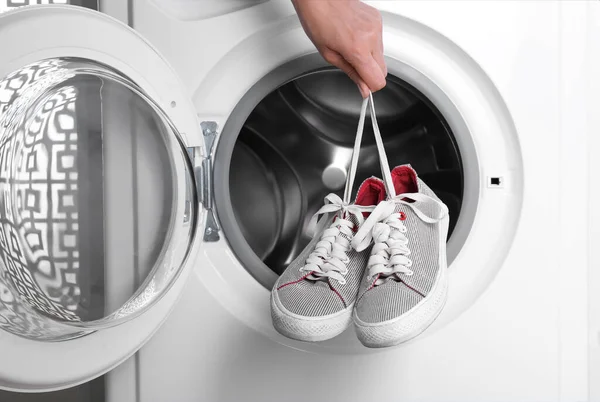 Woman Putting Pair Sport Shoes Washing Machine Closeup — Stock Photo, Image