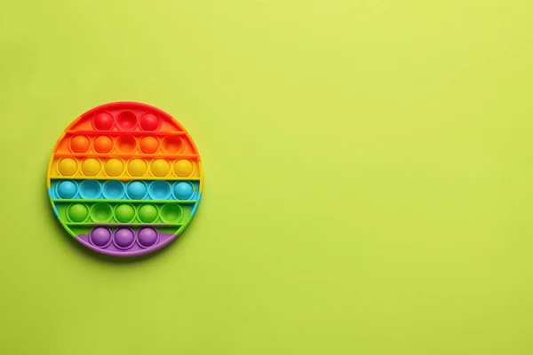 Rainbow Pop Fidget Toy Light Green Background Top View Пространство — стоковое фото