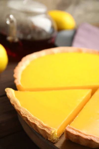 Delicious homemade lemon pie on wooden table, closeup