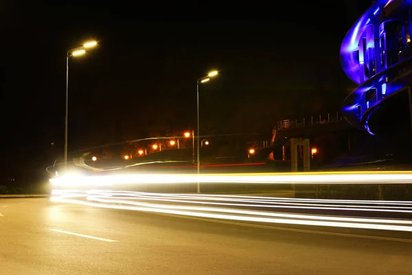 Road with light trails in modern city. Night life