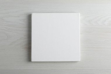 Beyaz ahşap arkaplanda boş tuval, metin için boşluk