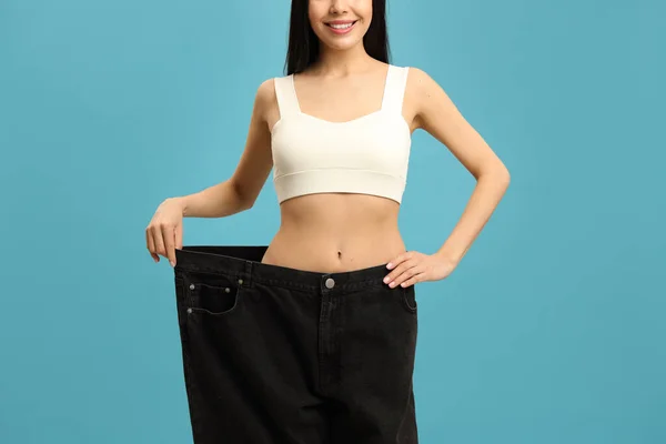 Happy Young Woman Wearing Big Jeans Weight Loss Turquoise Background — Photo