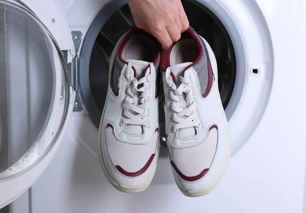 Woman Putting Pair Sport Shoes Washing Machine Closeup — Stock Photo, Image