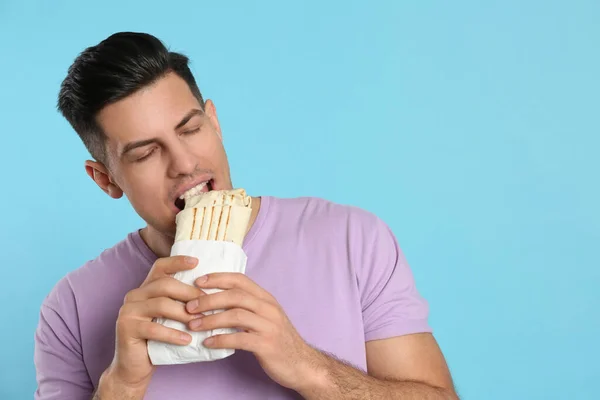 Man Eating Delicious Shawarma Turquoise Background Space Text — Stock Photo, Image