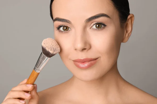 Beautiful Young Woman Applying Face Powder Brush Grey Background Closeup — Stock Photo, Image