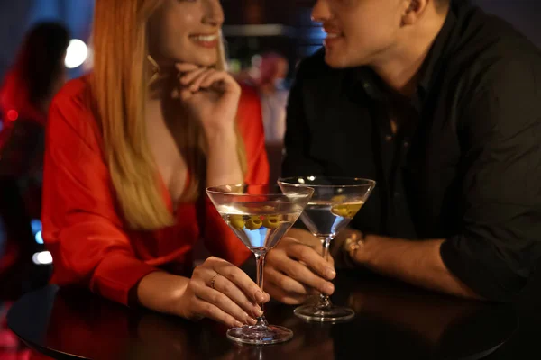 Man and woman flirting with each other in bar, closeup