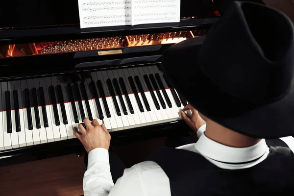 Man playing piano, above view. Talented musician