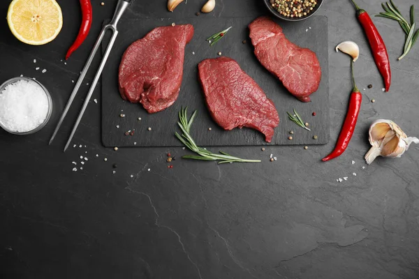 Fresh Raw Meat Steaks Spices Black Table Flat Lay Space — Stock Photo, Image