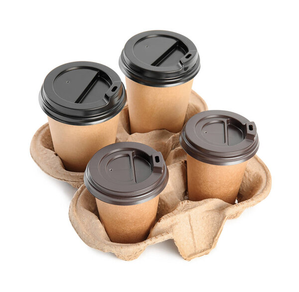 Takeaway paper coffee cups in cardboard holder on white background