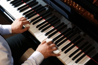 Man playing piano, above view. Talented musician clipart