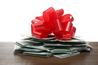 Beyaz arka planda kırmızı kurdeleli bir yığın banknot.