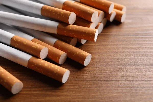 Pile Cigarettes Wooden Table Closeup — Stock Photo, Image