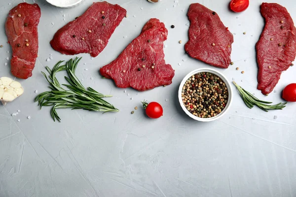 Fresh Raw Meat Steaks Spices Light Grey Table Flat Lay — Stock Photo, Image