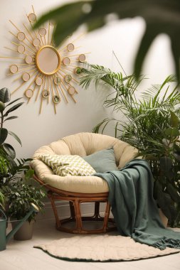 Lounge area interior with comfortable papasan chair and houseplants clipart