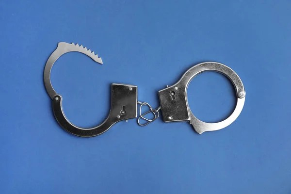 Classic Chain Handcuffs Blue Background Top View — Stock Photo, Image